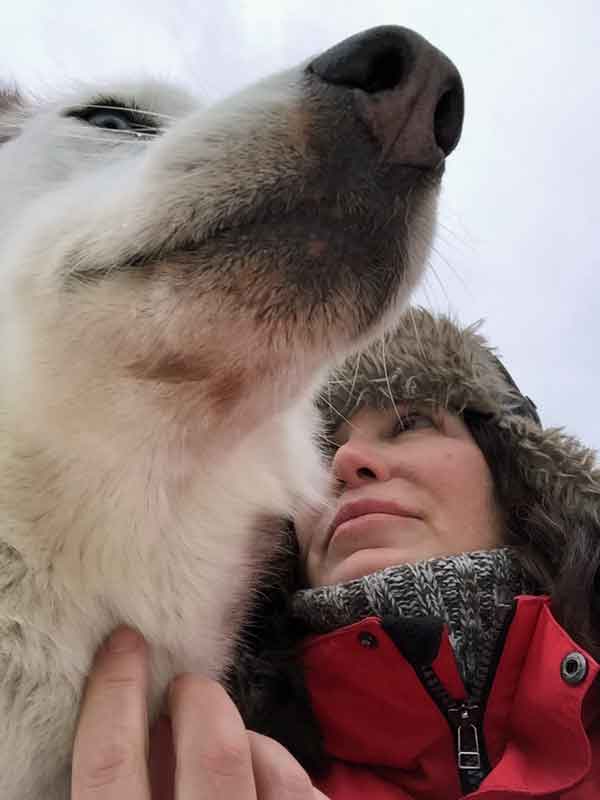 Happy dog and a happy musher (dog sled driver).