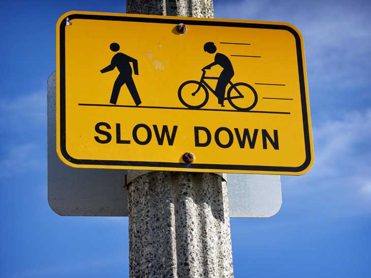 Follow road signs and traffic laws as a cyclist.