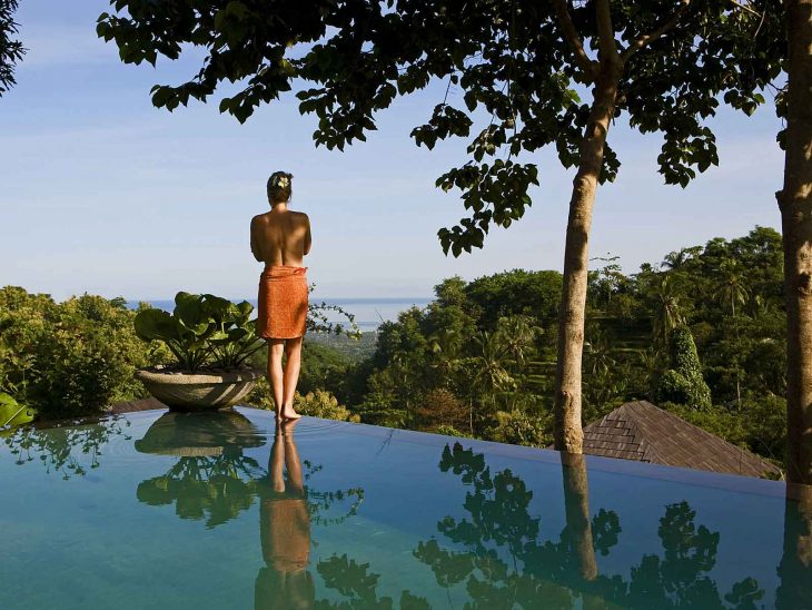 Woman by one of the villa pools at The Damai, northern Bali´s best luxury retreat.