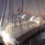 Large beds with mosquito net at Sandoway Resort in Ngapali Beach, Myanmar.