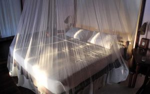 Large beds with mosquito net at Sandoway Resort in Ngapali Beach, Myanmar.