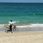 man with bicycle on the beach in Ngapali