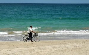 man with bicycle on the beach in Ngapali