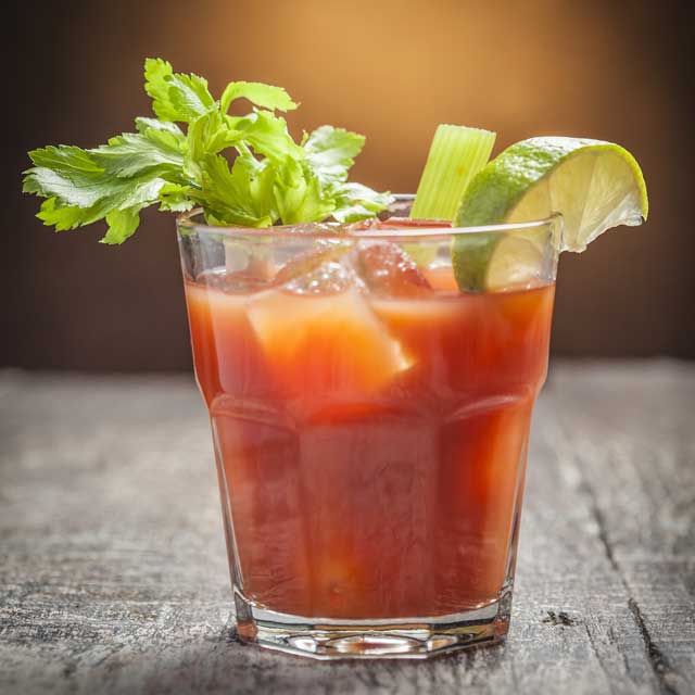 A classic Bloody Mary garnished with lemon, lime and a celery stalk.