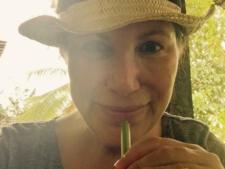 Karin drinking coconut water and feeling good in Ubud, Bali.