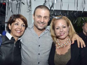 Greg Peter Patrikios, the founder of CIOOA, surrounded by 2 ladies.