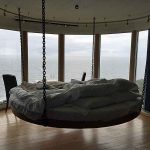 The bed is suspended from the ceiling at The Falcon´s Nest at Kullaberg.