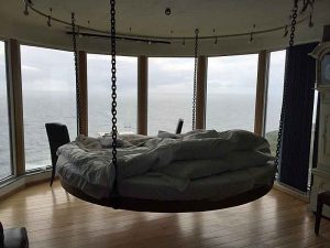 The bed is suspended from the ceiling at The Falcon´s Nest at Kullaberg.