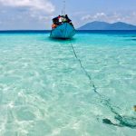 Boat anchored in the crystal clear waters of Karimunjawa where Kura Kura Resort is located.