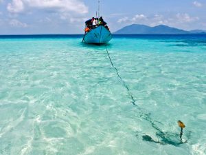 Boat anchored in the crystal clear waters of Karimunjawa where Kura Kura Resort is located.