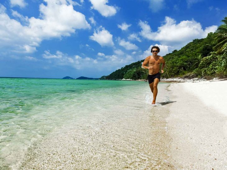 Man running on beach in Koh Samui