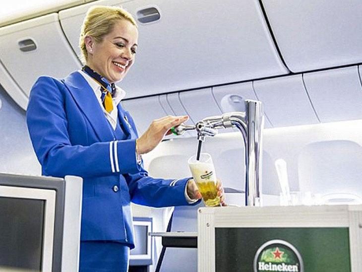 KLM hostess tapping beer in the air.
