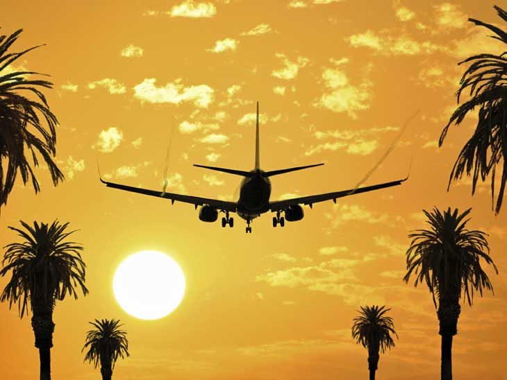 Airplane taking off in the sunset.