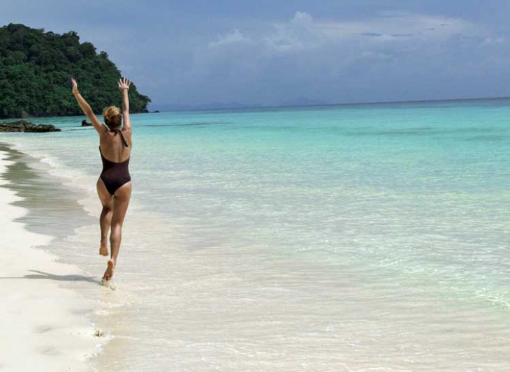 Happy girl on sunny beach.