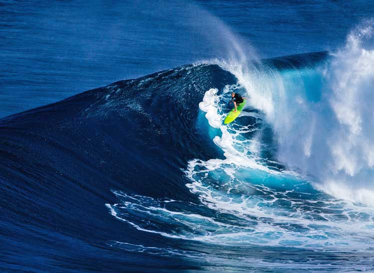 Surfer riding big wave.