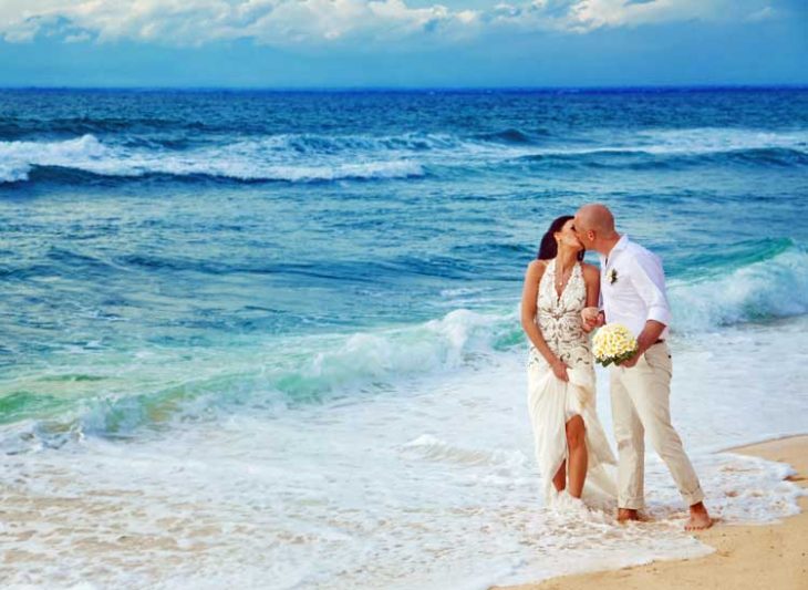 Couple kissing on the beach.