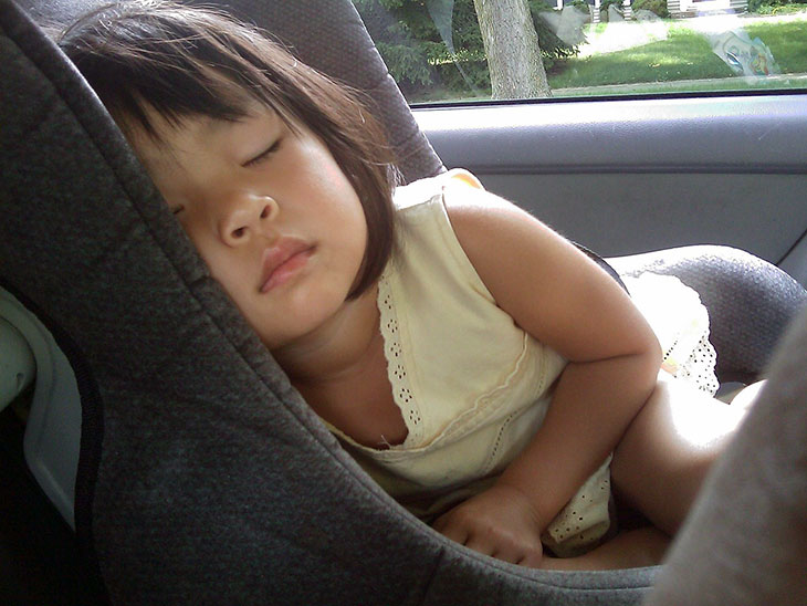 Child sleeping in car seat.