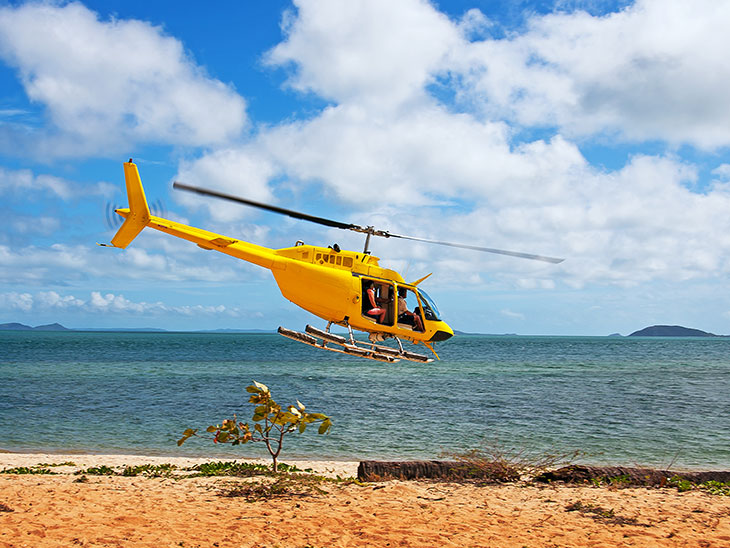 helicopter flying over the beach on the island of Mauritius